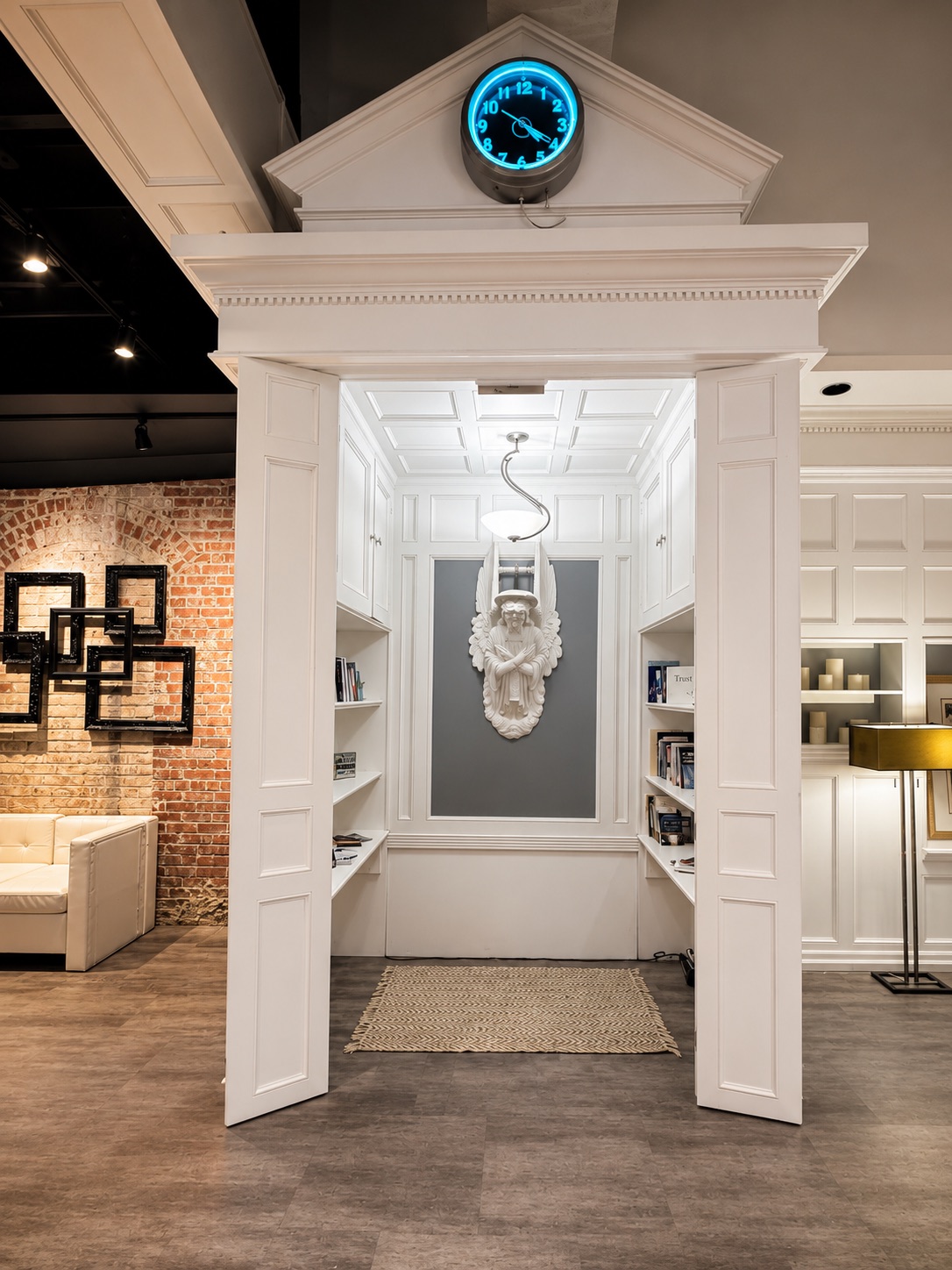 The club's white-paneled library nook, with bookshelves on either side of a sculptural wall detail