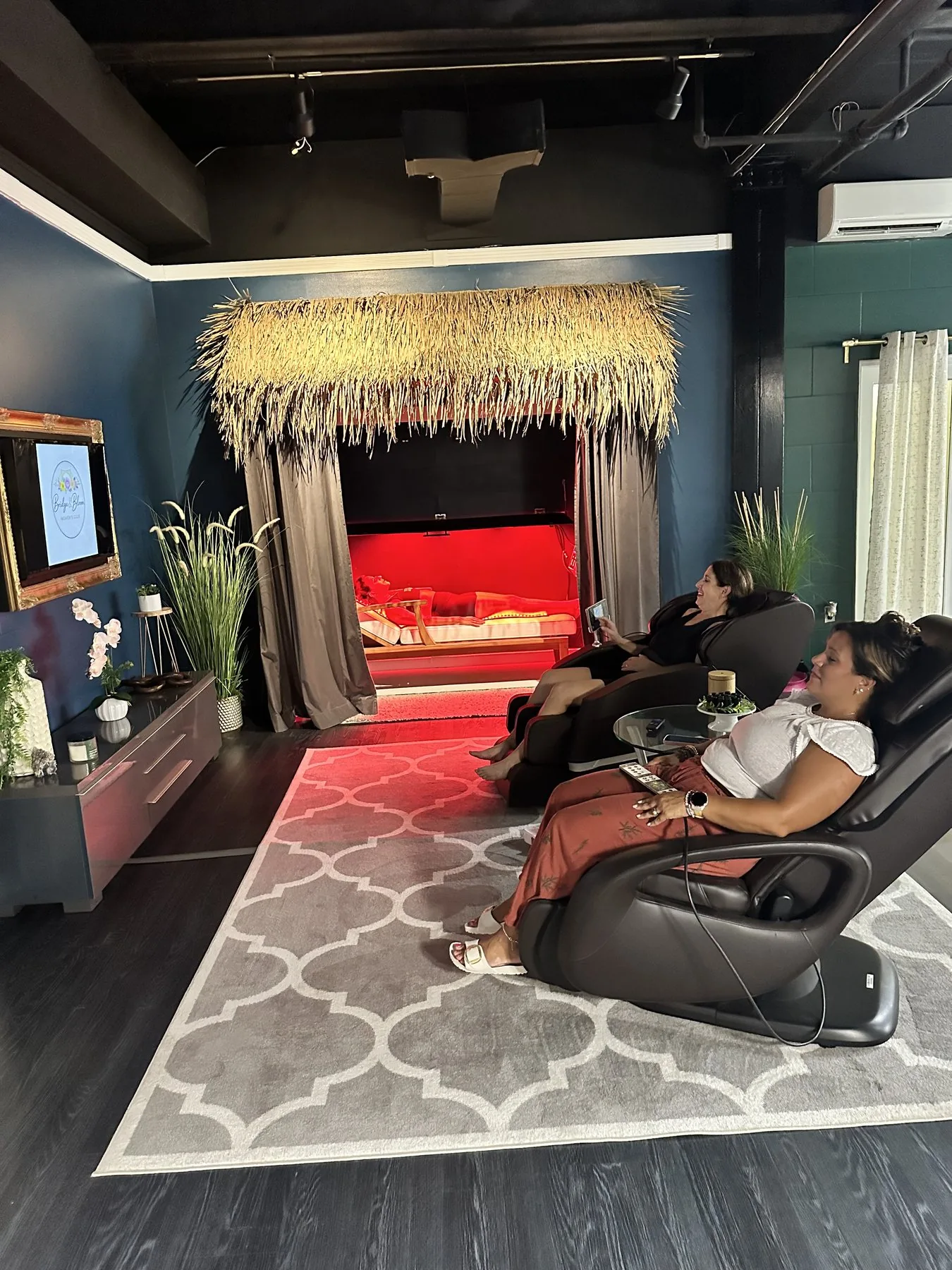 Members enjoying massage chairs and red light relaxation