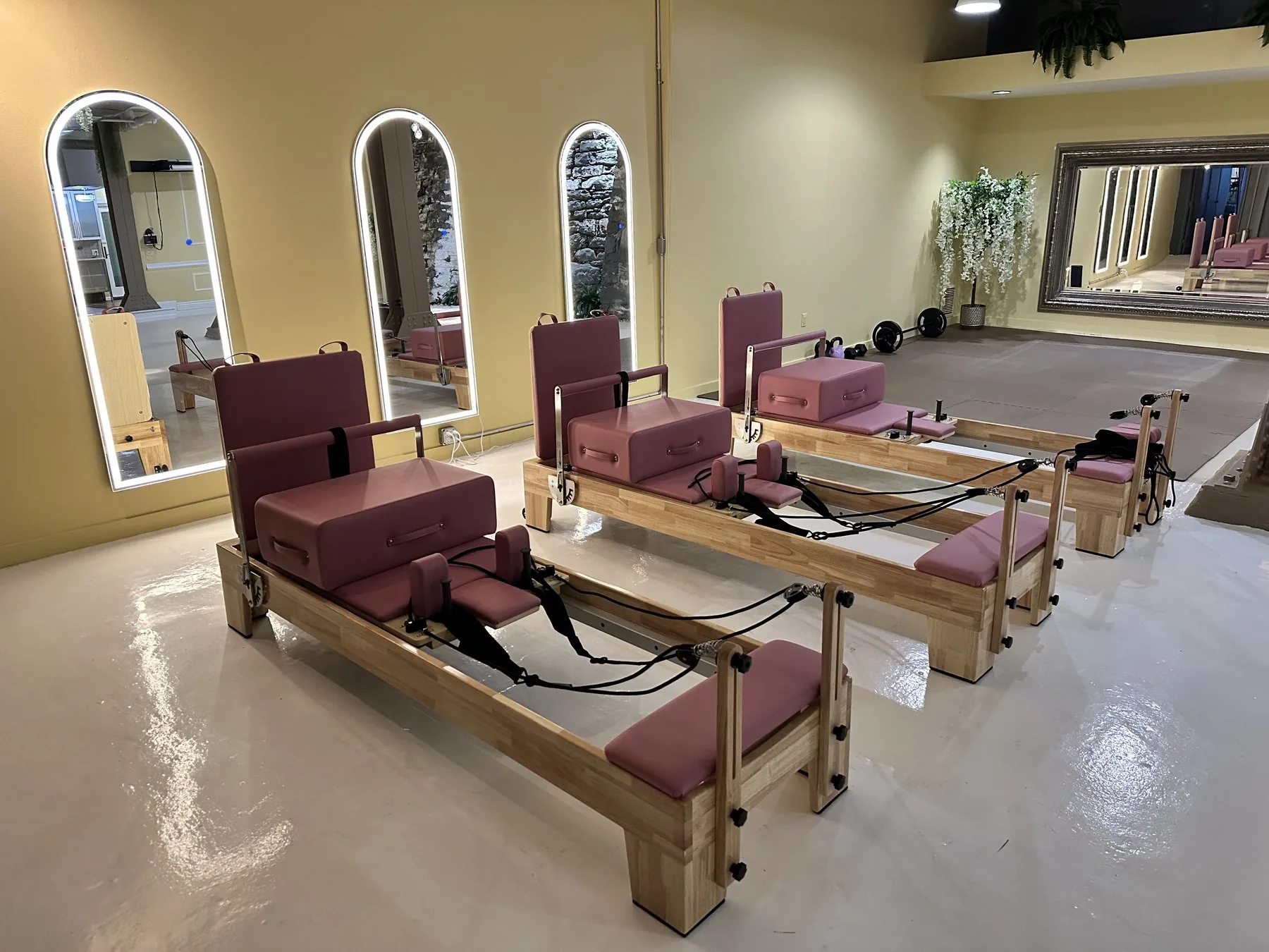 Pilates reformers ready for a Bridge and Bloom wellness session